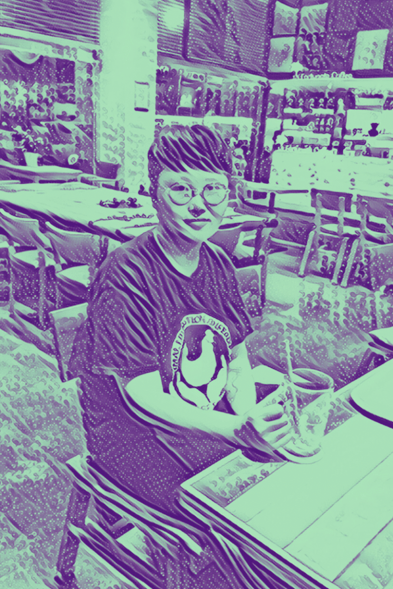 Stylized picture of Heeji Yi in a coffee shop, wearing an Animal Liberation T-shirt