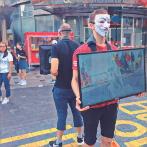 Masked animal activists show graphic footage on a busy street in Seoul.